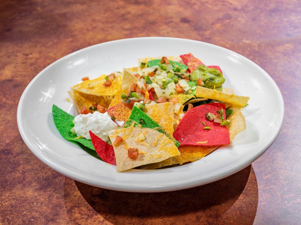 Nacho · Served with sour cream, salsa, and guacamole. Add beef or chicken for an additional charge.