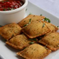Fried Ravioli · Cheese stuffed ravioli lightly breaded and fried, served with our homemade marinara sauce.