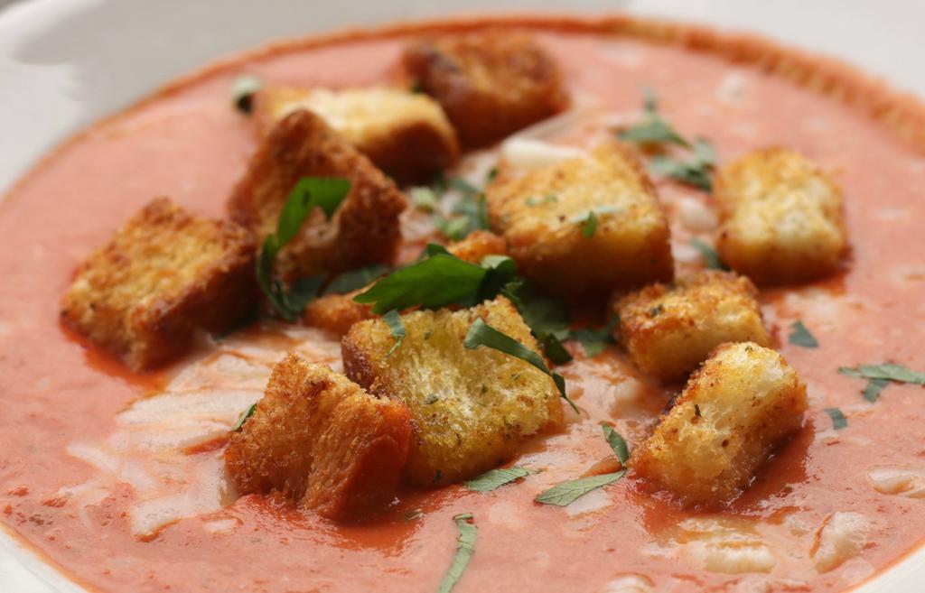 Tomato Bisque · Creamy tomato basil soup topped with mozzarella and garlic croutons tons.
