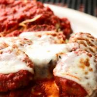 Meatball Parmigiana · 3 large homemade meatballs covered with mozzarella cheese and simmered in tomato sauce, serv...