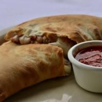 Cheese Calzone · Folded over pizza dough stuffed with ricotta and mozzarella cheese with a side of marinara f...