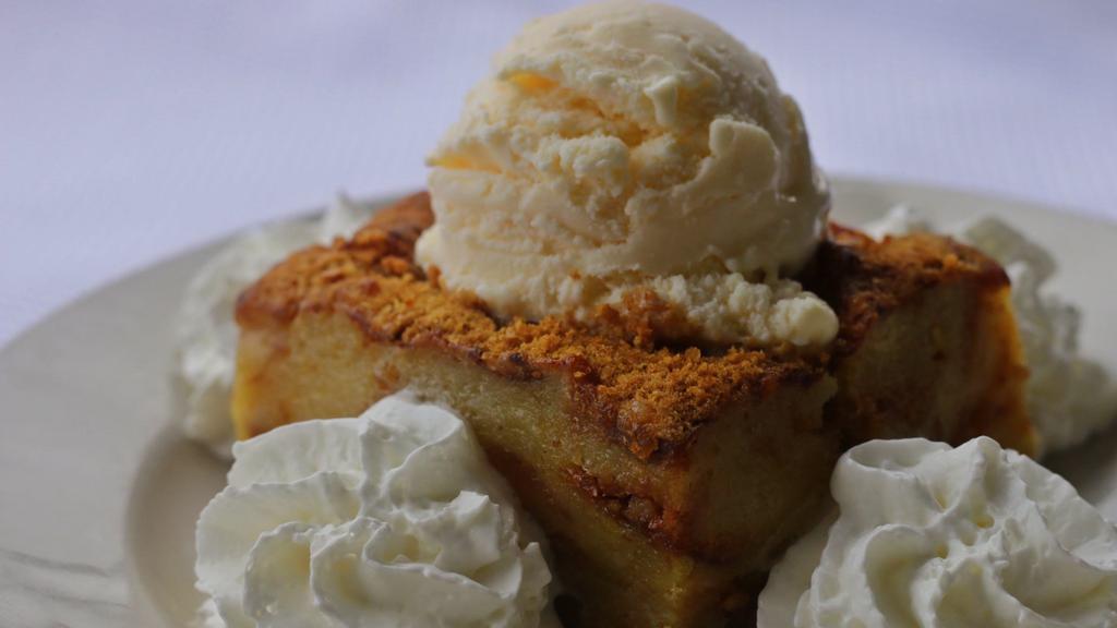 White Chocolate Bread Pudding · A creamy dessert laced with cinnamon and white chocolate, served warm with a side of vanilla bean ice cream.
