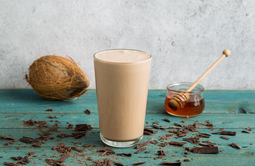 16 oz. Banana Wake-Up Call Smoothie · Banana, americano coffee, coconut milk, virgin coconut oil, Greek yogurt, unsweetened cocoa powder, honey, and oats.