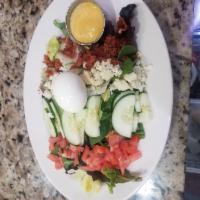 Cobb Salad · Mixed greens, hard boiled egg, cucumber, tomato, blue cheese and bacon, dressing of choice.