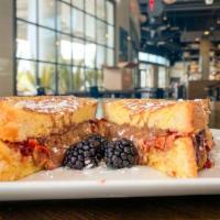 PB and J Nutella Melt · Peanut butter, Nutella and habanero-blackberry jam on French toast. Add bacon for an additio...
