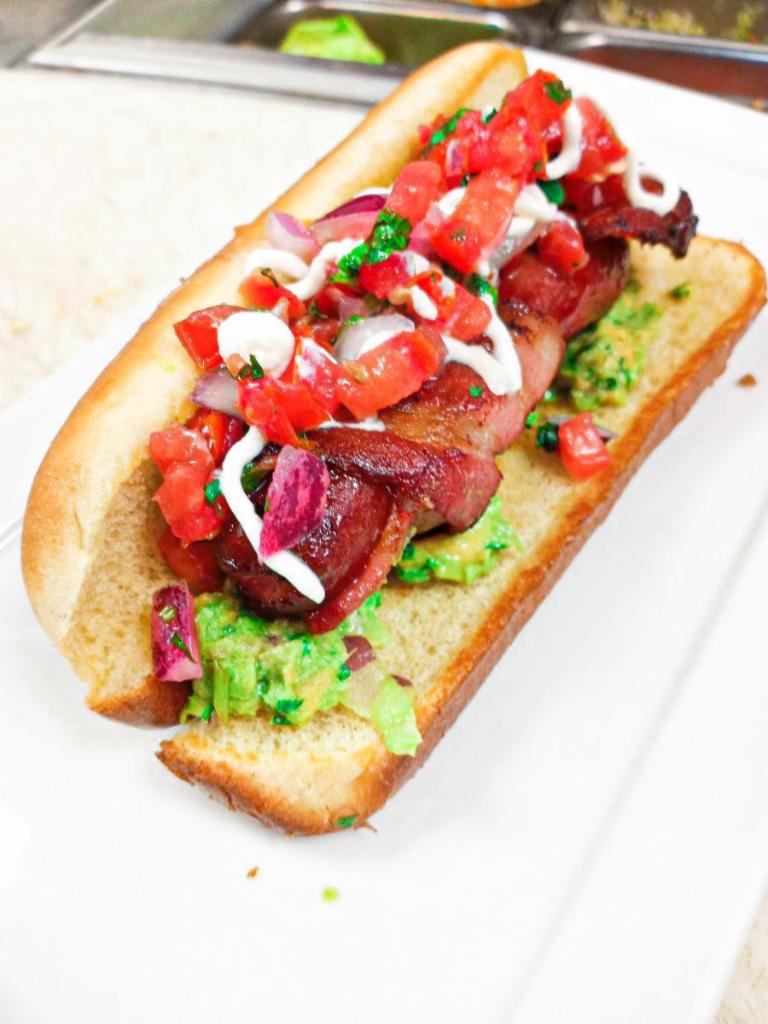 Street Hot Dog · Bacon wrapped beef hot dog, guac, pico, salsa verde.