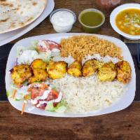 Chicken Kabob Platter · Grilled chicken breast served with fresh baked bread, steamed basmati rice and salad.