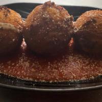 Arancini · Fried Arborio rice balls stuffed with cheese, peas, 
Ground beef, with parmesan with marinara