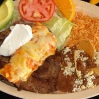 Carne a la Tampiquena · Skirt steak topped with a cheese suiza enchilada. Served with rice, beans and salad on the s...