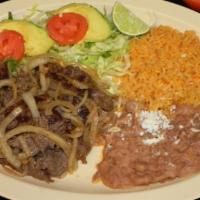 Steak Encebollado · Beef steak with sauteed onions. Served with rice, beans and salad on the side.