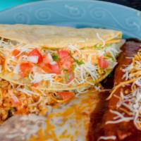 3. Enchilada and Taco · One enchilada topped with shredded cheese and red enchilada sauce garnished with lettuce and...