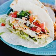 6. Two fish tacos · Two perfectly fried beer battered cod tacos served in a flour tortilla filled with cabbage, red onions, cilantro, pico de gallo, and jalapeno ranch.
Served with rice and beans.