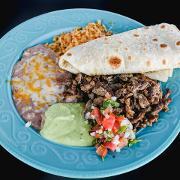 11. Carne asada plate · Delicious carne asada (grilled steak) platter garnished with pico de gallo, shredded cheese and lettuce, served with guacamole salsa and sour cream.
Served with rice, beans and a side of tortillas