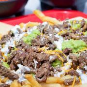 Supreme Cheese Fries · Full order of French Fries with the meat of your choice served with lettuce, shredded cheese, cilantro, guacamole, sour cream, and pico de gallo then covered with queso dip.
