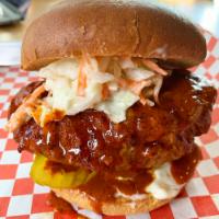 The Dirty Bird · Crispy Fried Chicken Breast smothered in a Georgia Peach
laced Spicy Nashville Sauce with Pi...