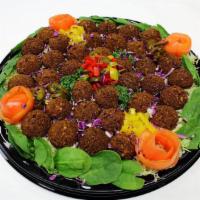 Catering Falafel Bar · Includes falafel balls, lettuce, tomatoes, pickled cabbage, banana pepper, tahini sauce, yel...