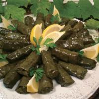 Vegan Stuffed Grape Leaves · Rice, Tomatoes, Onions, Bell Peppers, Parsely rolled in a Grape Leave cooked in Lemon Juice ...