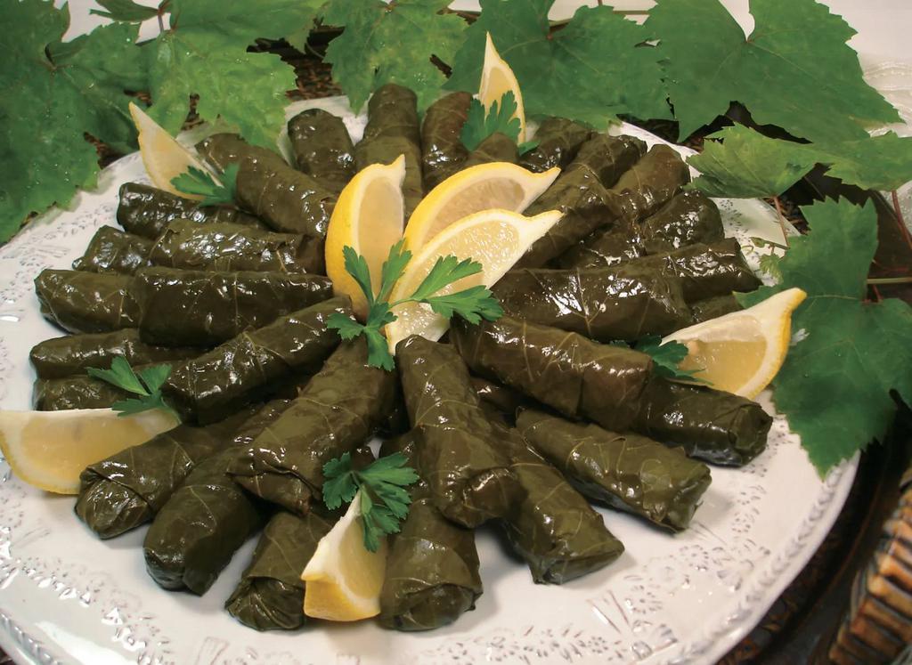 Vegan Stuffed Grape Leaves · Rice, Tomatoes, Onions, Bell Peppers, Parsely rolled in a Grape Leave cooked in Lemon Juice and other Seasoning *Price per 1/2 lb.