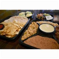 Taco Family Platter · Feeds 4-6 people. Taco bar includes shredded chipotle chicken, seasoned ground beef, refried...