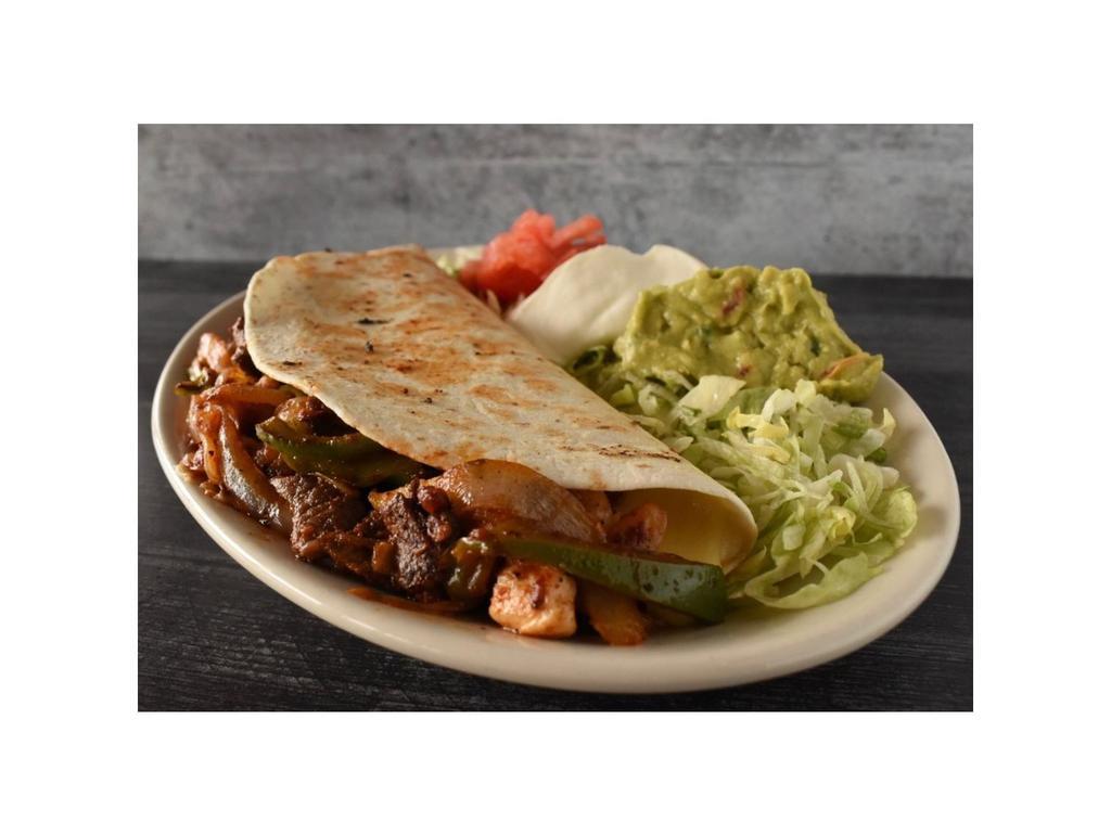 Fajita Quesadilla · Your choice of steak or chicken in a huge flour tortilla filled with onions, peppers, Ranchero Sauce and cheese. Garnished with lettuce, guacamole, sour cream and tomato.