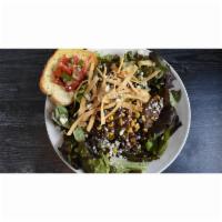 Santa Fe Salad · A bed of fresh salad greens layered with steak, fire roasted vegetables, tortilla strips, to...