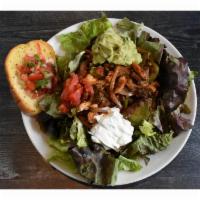 Fajita Salad · Crisp garden greens with fajita-style steak and chicken, bell peppers and onions. Topped off...