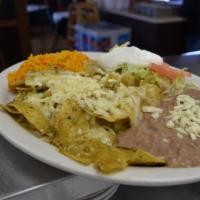 Chilaquiles · Tortilla chips, eggs, cilantro, onions and cheese cooked with red or green salsa.