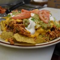 Super Nachos · Comes with lettuce, tomatoes, beans, cheese, sour cream, guacamole and choice of protein.