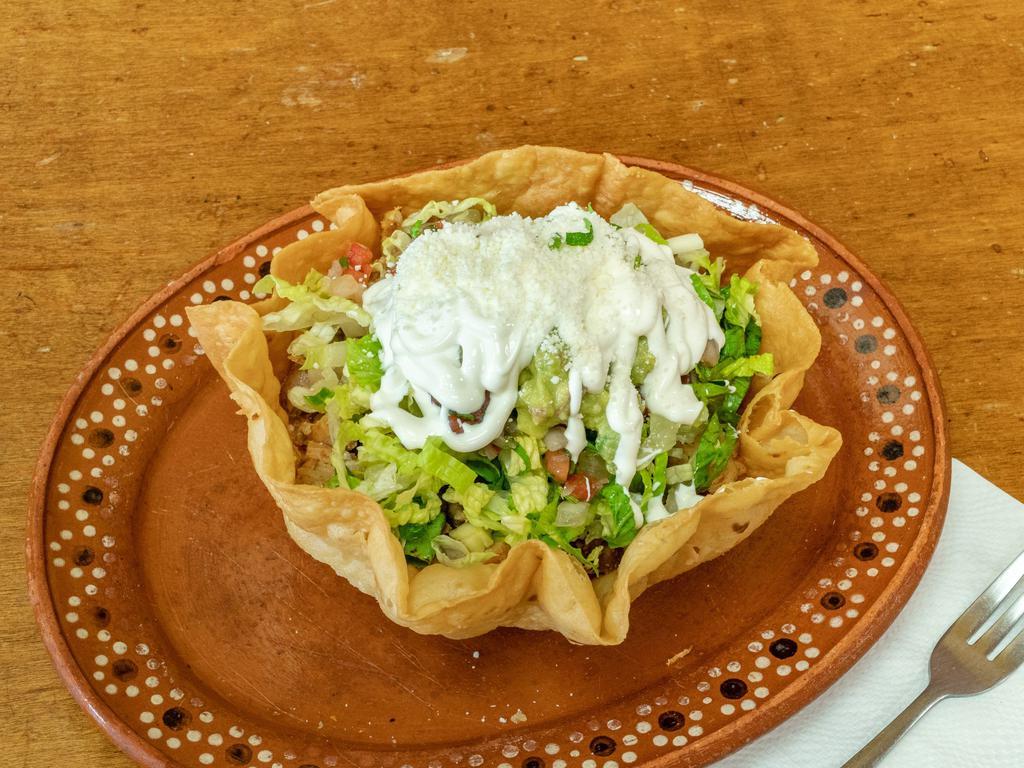 Taco Salad · Your choice of meat, rice, black beans, cheese, lettuce, pico de gallo, guac and sour cream.