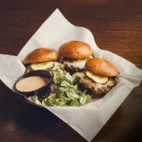 Dinky Burgers · Three mini burgers topped w/ white cheddar cheese, grilled red onions & pickles on brioche r...