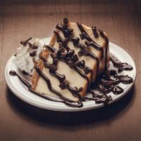 Chocolate Cheesecake · A colossal slice of New York cheesecake topped w/ chocolate sauce, shaved chocolate and whip...