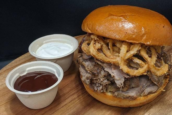 Tri-Tip Sandwich · Marinated and roasted Tri-Tip on a brioche bun, with crispy onion straws on top. Served with homemade horseradish aioli and kickin' bbq sauce on the side.