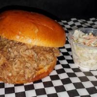 Pulled Pork Sandwich · Our homemade low-n-slow pulled pork, piled high on a brioche bun, with BBQ sauce and colesla...