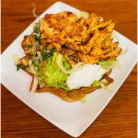 Taco Salad · A crispy flour tortilla bowl filled with your choice of chicken or beef topped with beans, c...