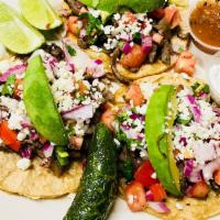 Cantina Tacos · Three tacos with choice of carnitas, steak, chicken, shrimp or fish, topped with homemade pi...