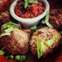 Meatballs · 4 beef and pork meatballs served with a side of our house red sauce. 
