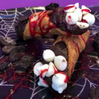 Death by Chocolate Cannoli  · 2 double chocolate cookie dough filled cannoli with Dracula blood and dirt (Oreo’s).