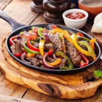 Steak Fajitas · Broiled sizzling fajitas marinated in our own special spices served with pico de gallo, sour...
