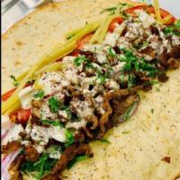 Beef Shawarma Panini · Parsley, tomatoes, onions, Lebanese wild pickles, tahini, spices. Panini press