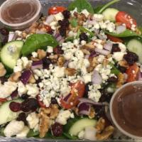 Skinny Salad · Spinach, tomato, cucumber, red onion, cranberries, walnuts, and blue cheese.
