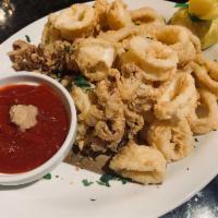Fried Calamari · Marinated in milk to tenderize then lightly battered and flash-fried until golden. Served wi...