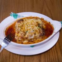 Mile High Lasagna · Meat lasagna layered in a casserole pan and topped with mozzarella and Fontinella cheese.  