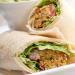 Falafel Sandwich · Falafel with hummus spread topped with cucumber, tomatoes, onion and a tahini lemon dressing...