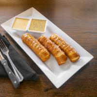 Warm Pretzels · Served with cheese fondue and whole grain mustard sauce. Vegetarian.