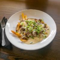 Poutine · Crispy fries smothered with shepherd's pie, brown gravy, and queso.