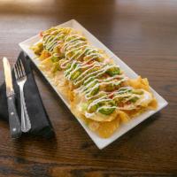 Nachos · Spicy! Crisp tortilla chips topped with cheddar, tomato, scallion, fresh jalapeno, queso, so...