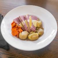 Corned Beef Brisket and Cabbage · Thick sliced house-cured corned beef brisket, served with braised cabbage, carrots, and pota...