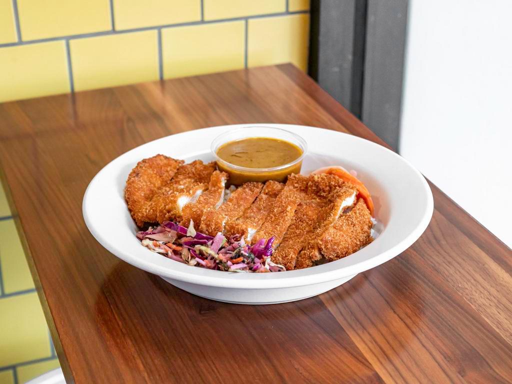 Chicken Katsu Rice Bowl · Chicken breast breaded with our house spice blend and panko then fried to perfection. Served over chicken rice with sesame slaw, fukujinzuke, and our house-made tonkatsu sauce.