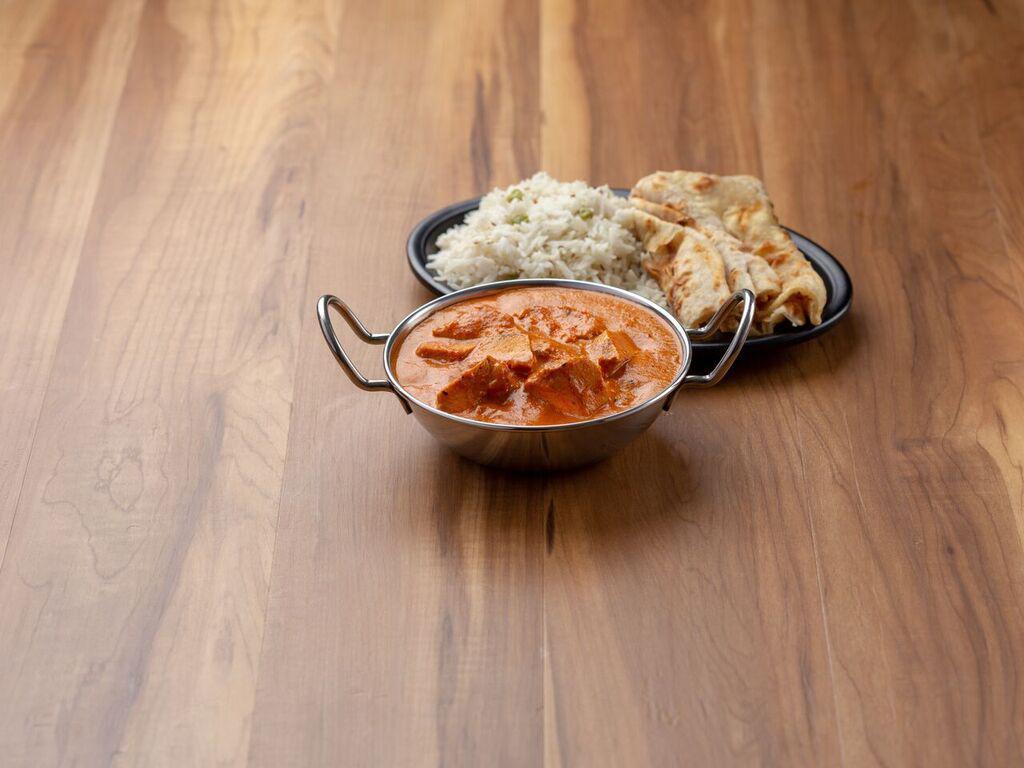 Chicken Tika Masala · Pieces of marinated chicken grilled and sauteed in aromatic masala. Served with rice and raita.