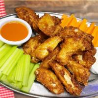 Chicken Wings · Chicken wings accompanied by celery and carrot pieces, blue cheese, Buffalo sauce.
